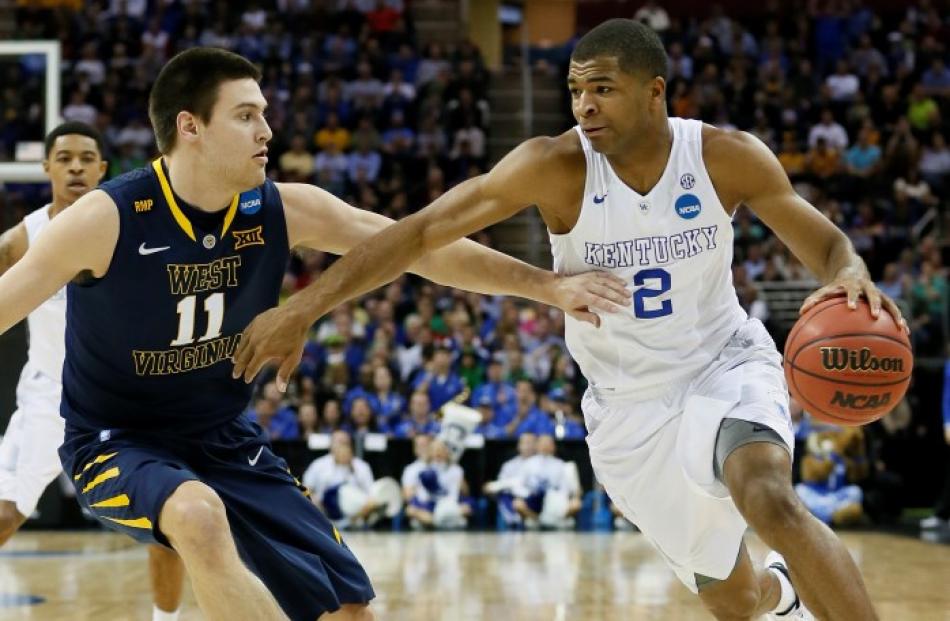 Key man for Kentucky . . . Wildcats guard Aaron Harrison in action against the West Virginia...