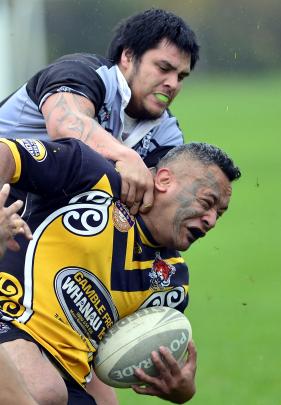 Kia Toa's Nolan Ratu is tackled by Reggie Parata, of the South Pacific Raiders, during an Otago...