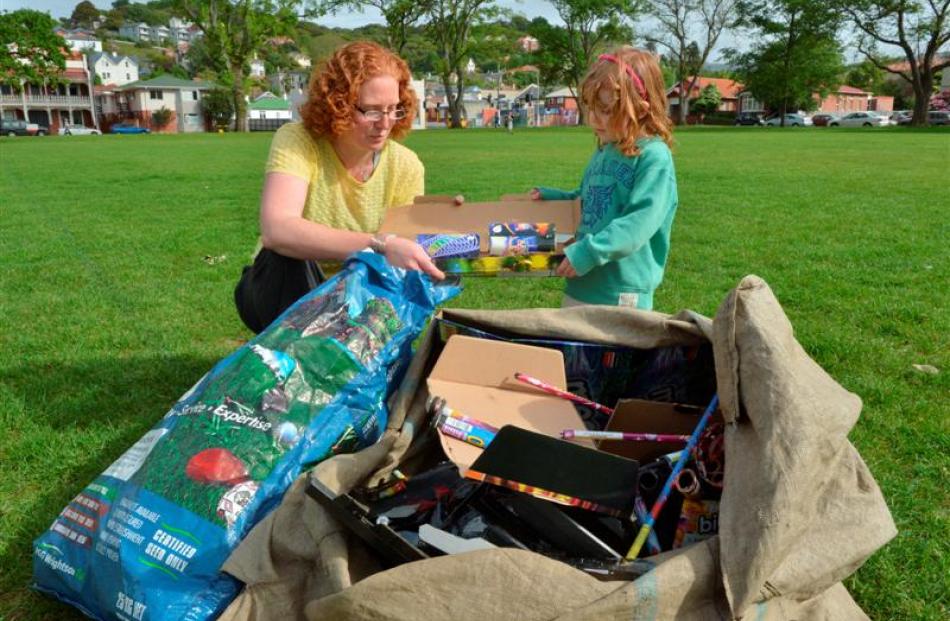 Kimberly Smith with daughter Amelia Smith (3) with some of the used fireworks collected from...