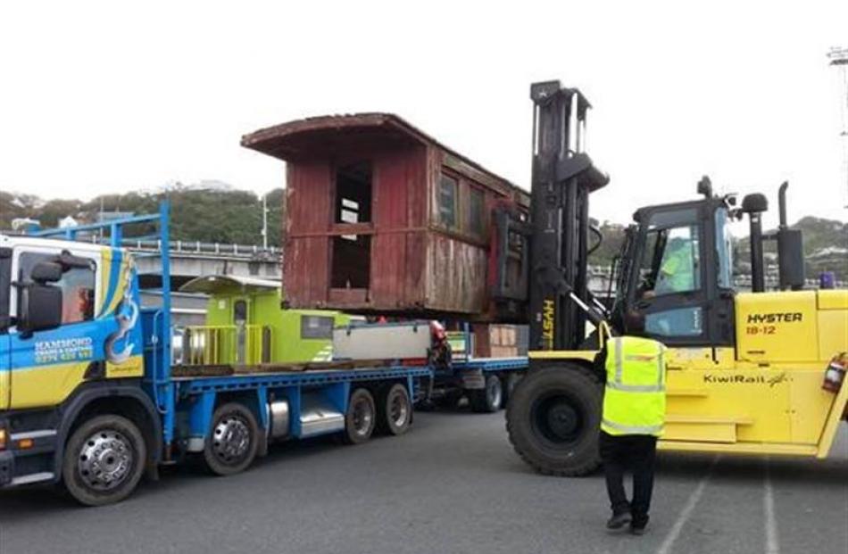 KiwiRail staff transfer one half of an A255 carriage, found on the Taieri, to a truck in...