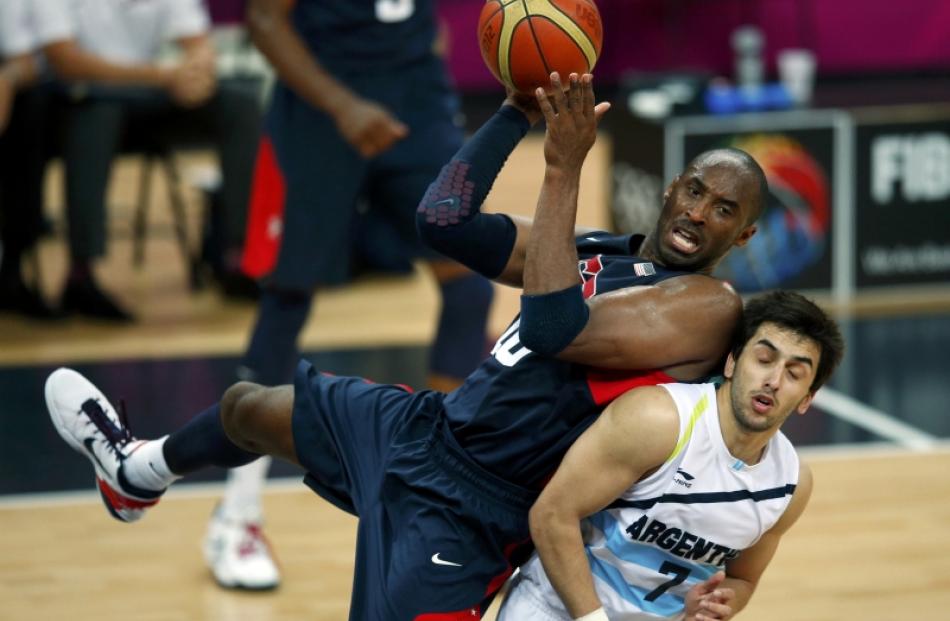 Kobe Bryant (left), of the US, looks to make a pass while resting on the back of Argentina's...