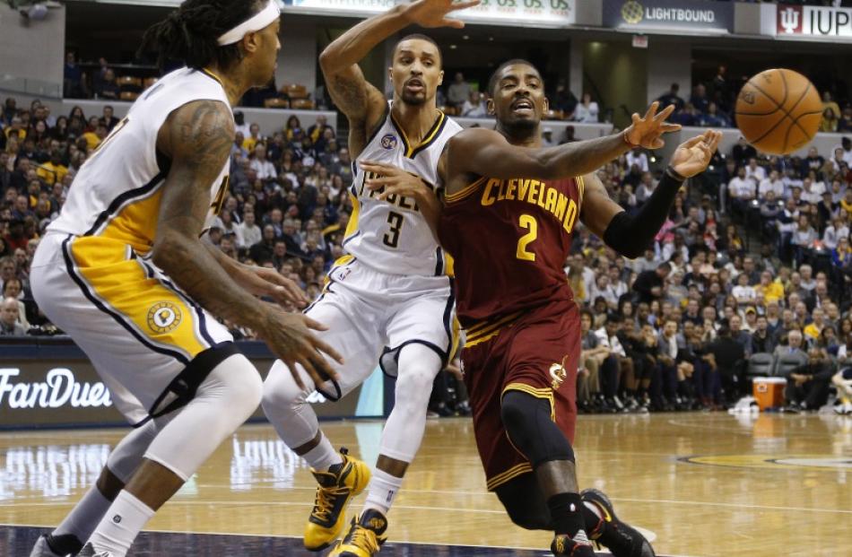 Kyrie Irving passes the ball out after committing two defenders on the dribble-drive penetration....