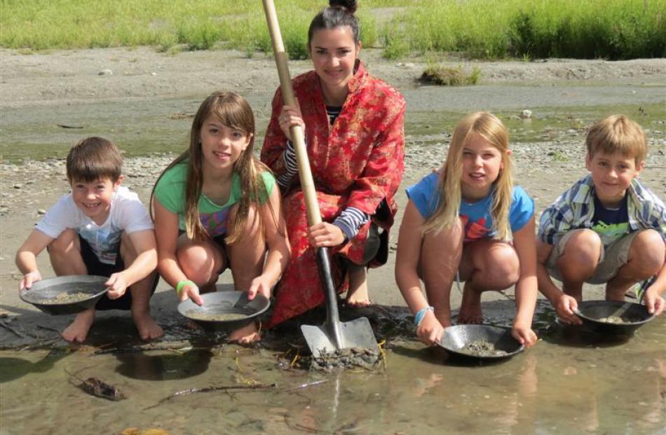 Lakes District Museum education officer Amy Taylor practises gold panning in the Arrow River with...