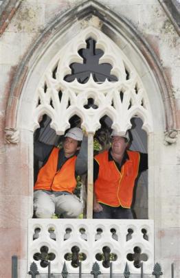 Stonemasons Marcus Wainwright and Craig Morton check the fit of part of an Oamaru stone window