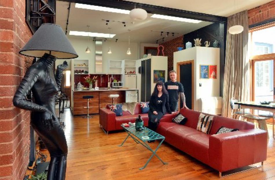 Lawrie and Sarndra Forbes in their warehouse apartment. ''Lucy the lamp'' (at left), was bought...