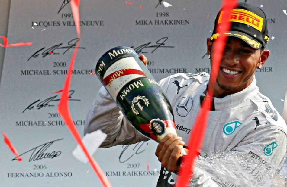 Lewis Hamilton celebrates on the podium after winning the Italian Grand Prix in Monza. REUTERS...