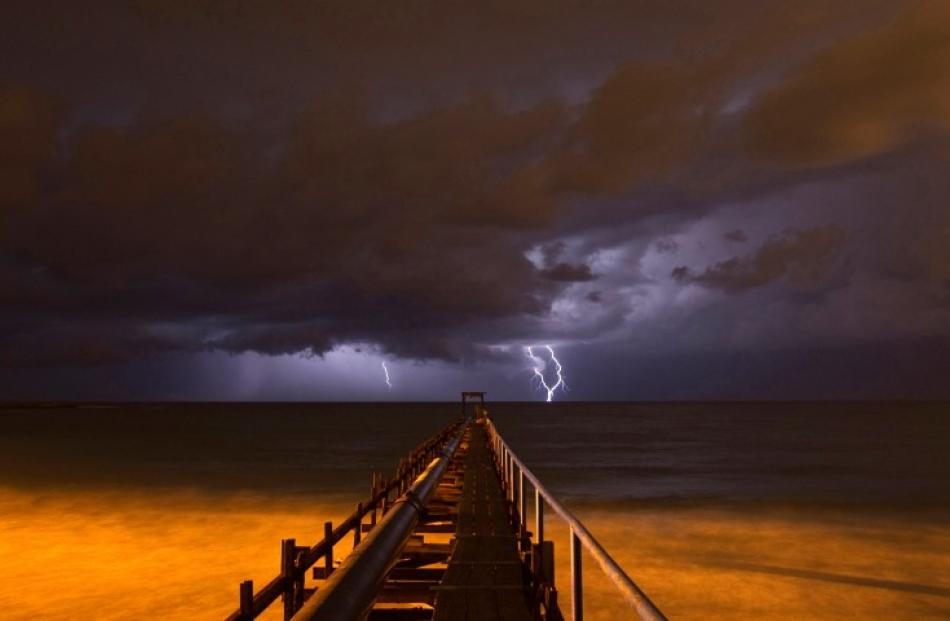 Lightning strikes over a pier during a storm in Atlit, near the northern Israeli city of Haifa in...