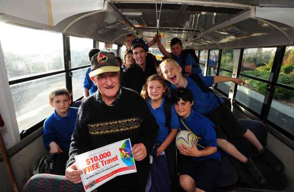 Lindsay Wright and Balclutha Primary School pupils on his bus celebrate his big travel win,...