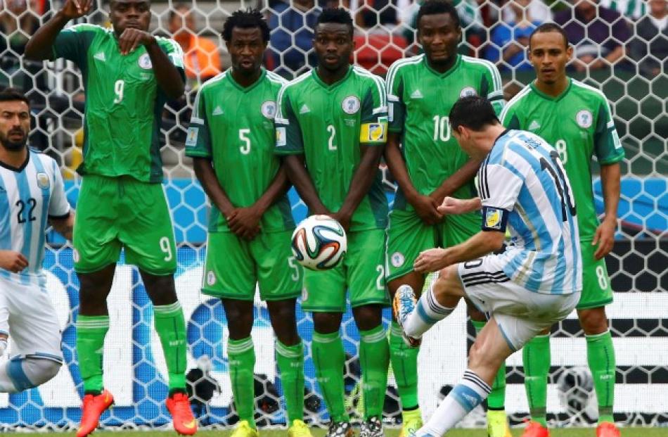 Lionel Messi shoots at goal from a free kick against Nigeria. REUTERS/Stefano Rellandini