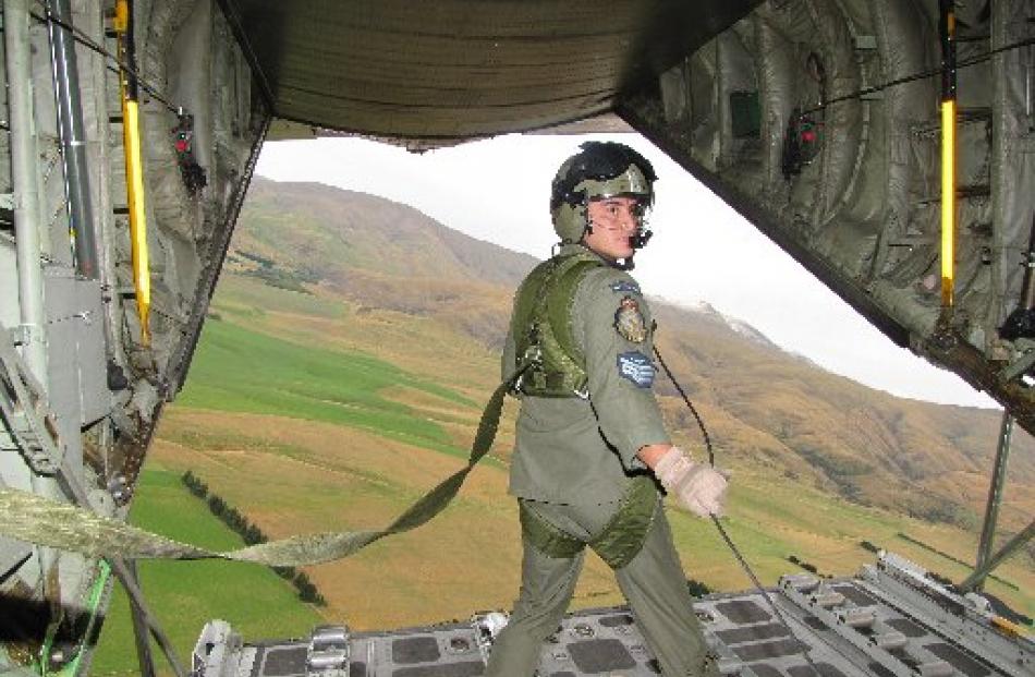 Loadmaster Sergeant Rodrigo Arriagada ventures to the end of the plane after the load is dropped....