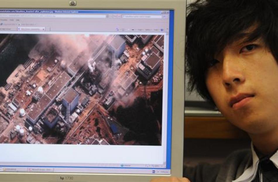 Logan Park High School international prefect Shunya Yago (18) keeps a watchful eye on...