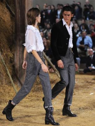 Long-time companion of Karl Lagerfeld, Baptiste Giabiconi (right) and a model walk the runway in...