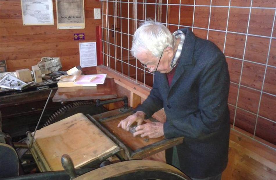 Lou Young, from the  Ferrymead Printing Society, Christchurch, locks the type for the first print...