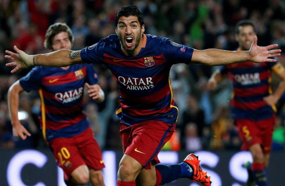Luis Suarez celebrates after scoring the winning goal for Barcelona in their Champions League...