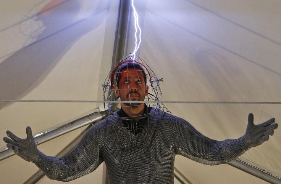 Magician David Blaine performs a demonstration of his upcoming performance "Electrified" during a...