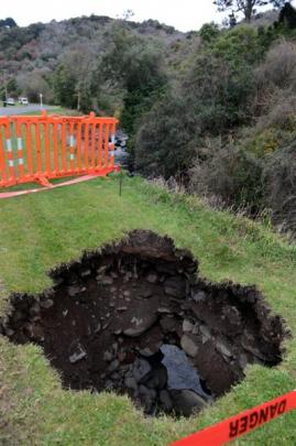 Malvern St, Woodhaugh, residents are sick of waiting for sinkholes caused by an eroding stream...