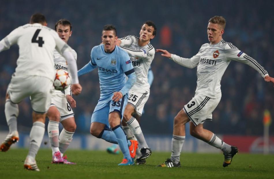 Manchester's City's Stevan Jovetic (C) is challenged by CSKA Moscow's players during their...