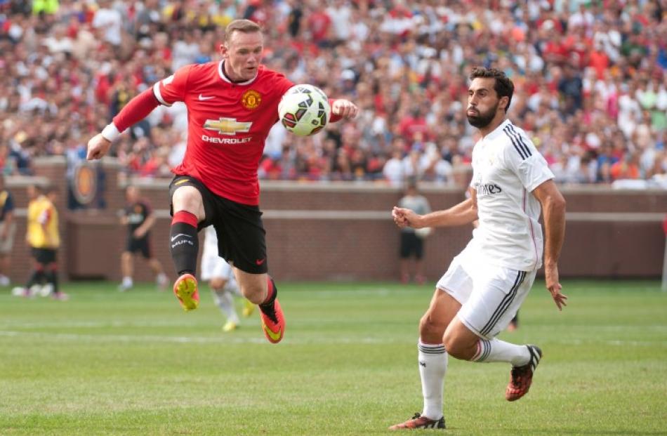 Manchester United forward Wayne Rooney (10) goes for the ball against Real Madrid defender Alvaro...