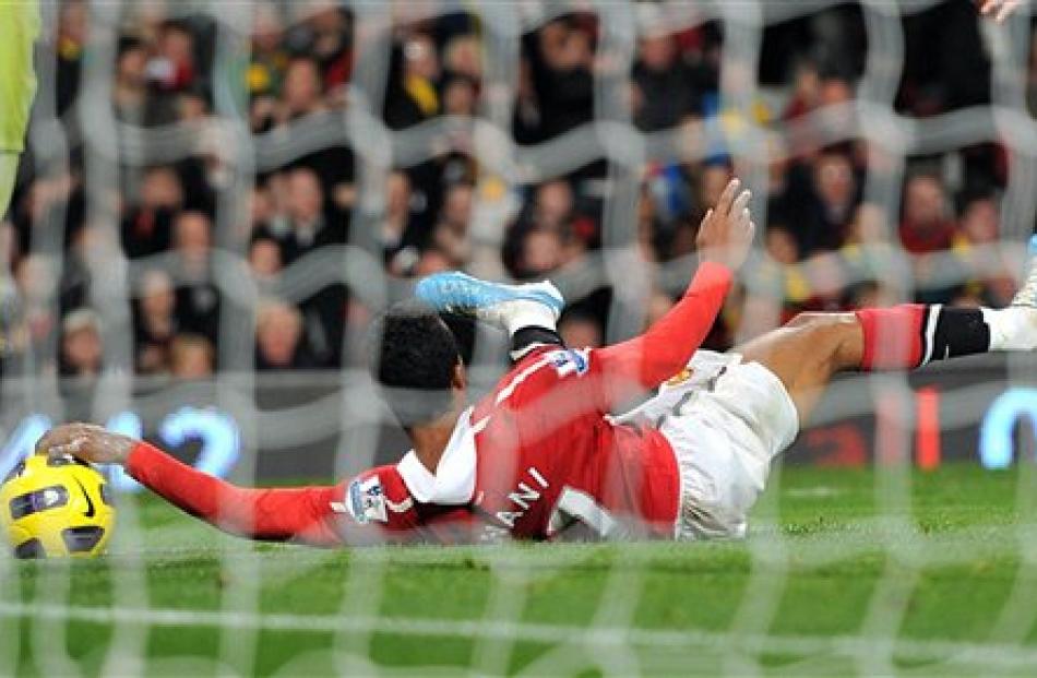 Manchester United's Nani handles the ball after falling in the penalty area just prior to scoring...