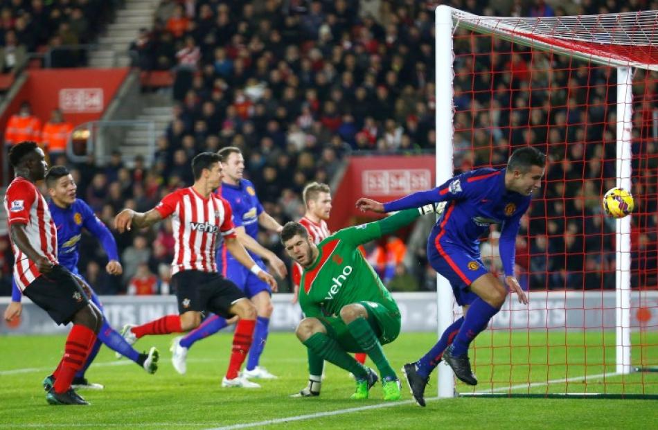 Manchester United's Robin van Persie (R) scores his second goal against Southampton during their...