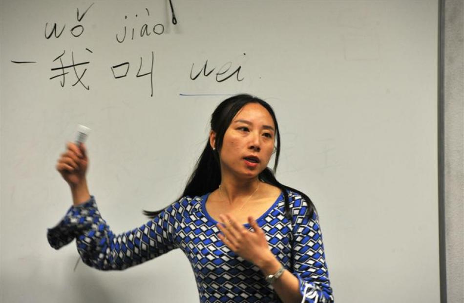 Mao Wei gives a lesson in Chinese writing. The  characters read: ''My given name is Wei''. Photos...