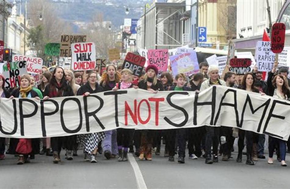 Marchers walk down George St on Saturday during the Dunedin Rape Crisis "Slutwalk" rally against...