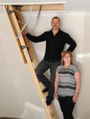 Mark and Hayley McHutchon from Otago Skylights and Heating demonstrate the use of attic stairs at...