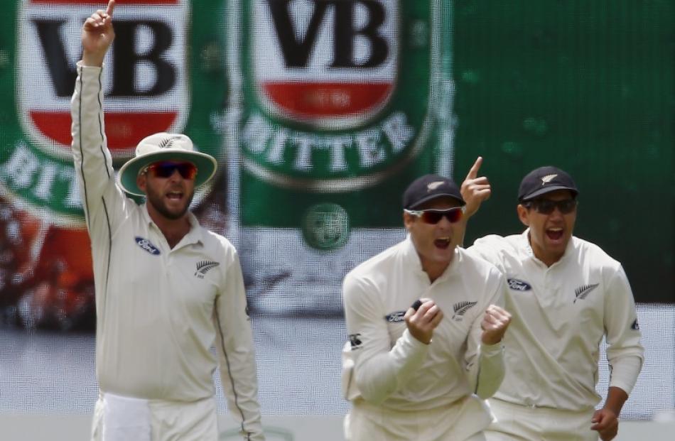 Mark Craig (L) and Martin Guptill (centre) appeal during the recent series in Australia alongside...