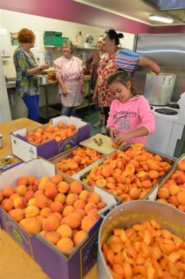 Maruia Vaitupu-Bachop (10), of Normanby, prepares hundreds of Central Otago apricots for jam and...