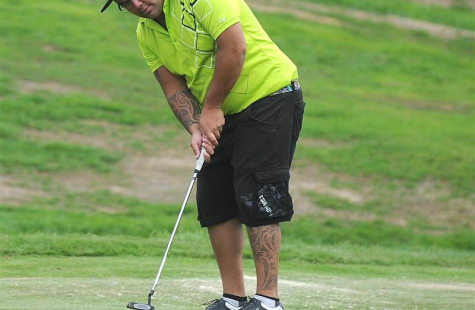 Matt Tautari attempts to hole a putt on the 15th green at St Clair Golf Club yesterday. The shot...