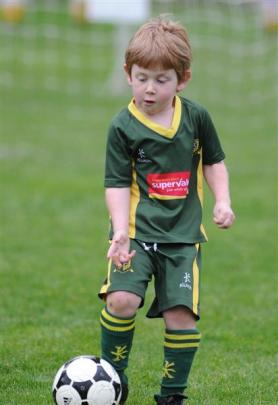 Matthew Barrett (5) shows his ball-dribbling skills for the Green Island Wildcats. Photos by...