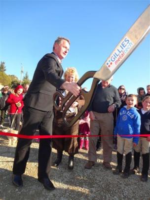 Mayor Gary Kircher cuts the ribbon to open the newly rebuilt section of Haven St, Moeraki, in...