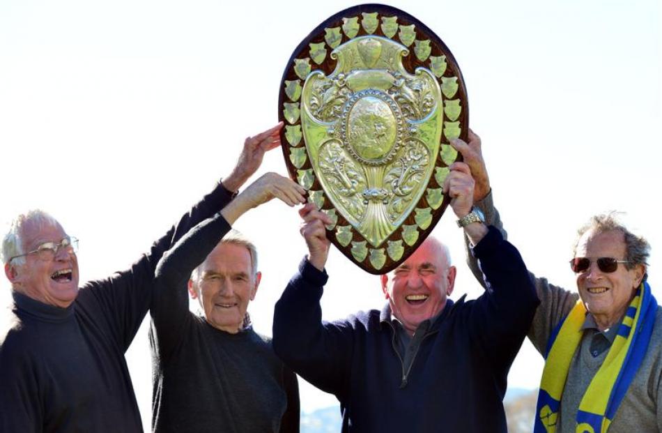 Members of the 1957 Otago team with the Ranfurly Shield yesterday at Bathgate Park, Dunedin, are ...