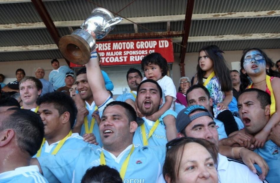 Members of the East Coast rugby team celebrate after winning the Meads Cup final between East...