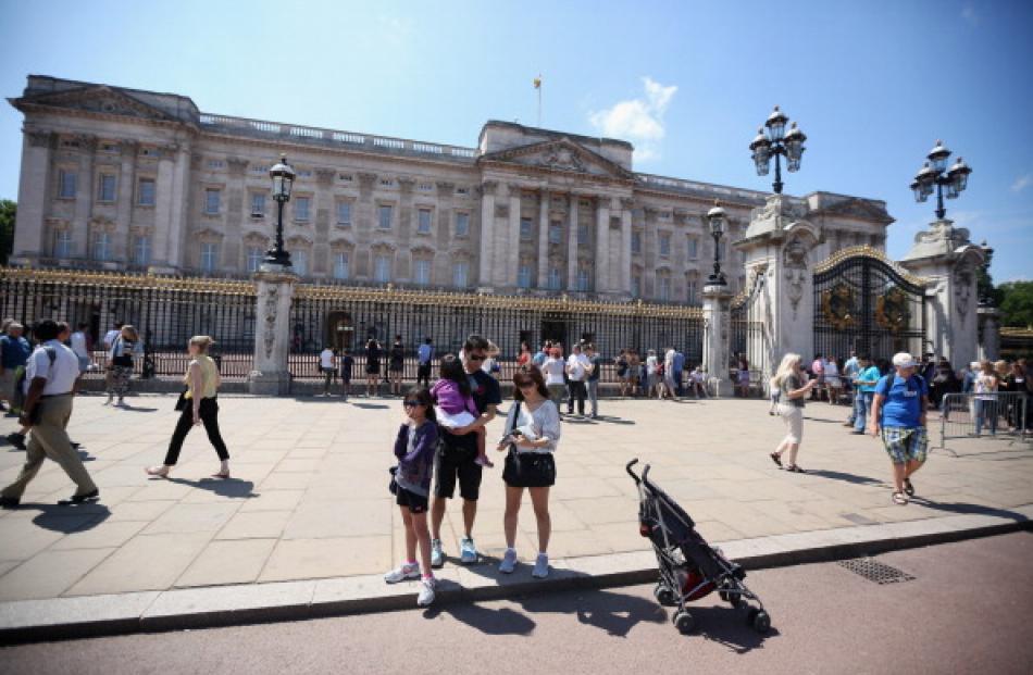 Members of the public admire Buckingham Palace. Photo Getty Images
