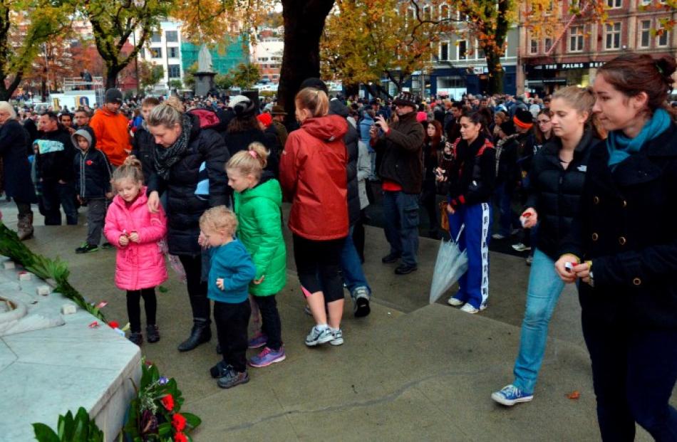 Members of the public place poppies on the cenotaph at the conclusion of the Dawn Parade.