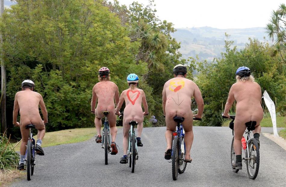 Members of the Southern Free Beaches naturist club ride along Doctors Point Rd in Waitati as part...