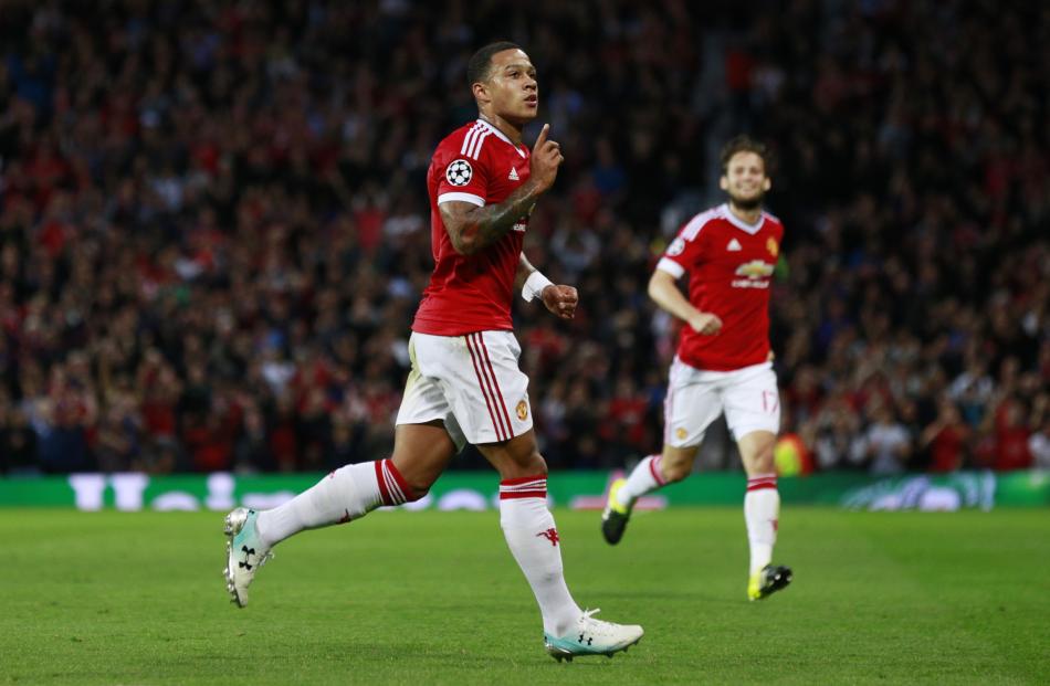 Memphis Depay celebrates after scoring his second goal in Manchester United's win against Club...