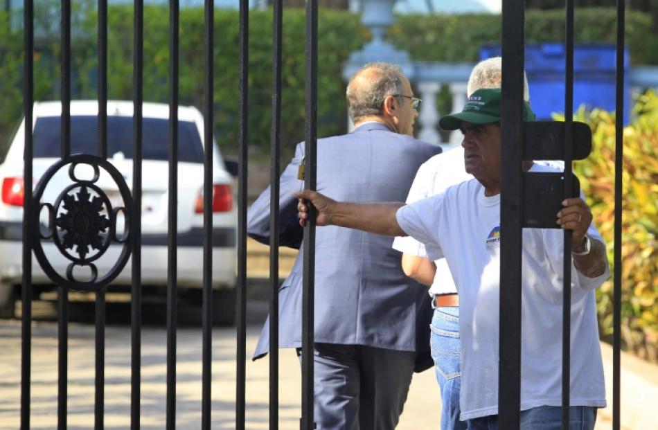Men arrive at a court during the trial against Sarkis Yacoubian and Krikor Bayassalian in Havana....