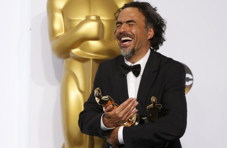 Mexican Director Alejandro G. Inarritu holds his three Oscars for for his film "Birdman" which...