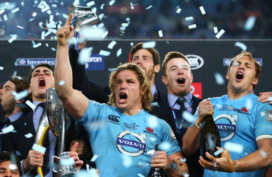 Michael Hooper (C) celebrates with Waratahs teammates after beating the Crusaders in the Super 15...