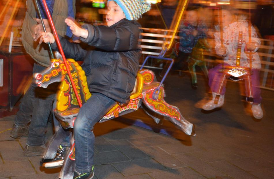 George Ripley (6), of Opoho, rides the merry-go-round.