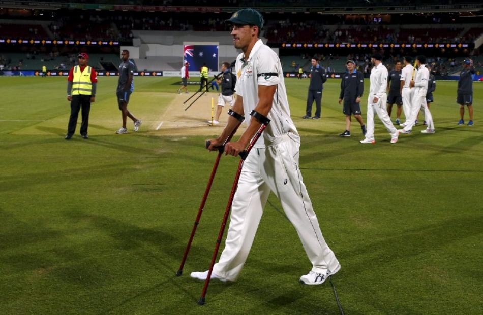 Mitchell Starc uses precautionary crutches during the presentation after the third test between...