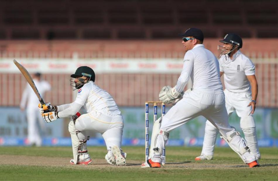 Mohammad Hafeez plays a sweep shot as Jonny Bairstow looks on. Photo: Reuters