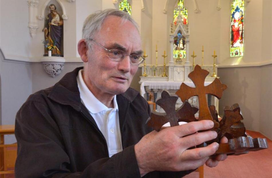 Monsignor John Harrison with ornamental crosses snapped from choir stools in the St Joseph's...