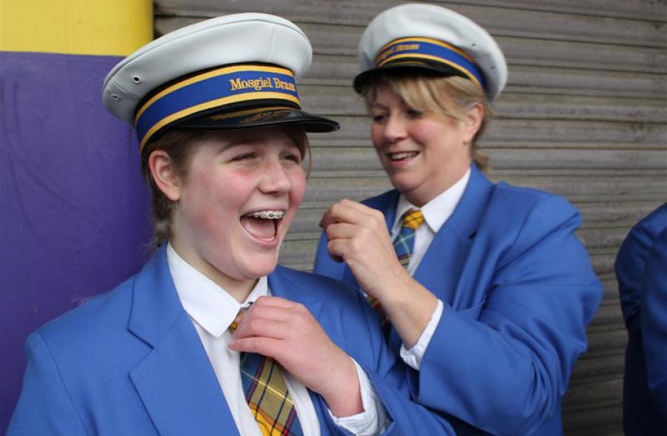 Mosgiel Brass member Cathy Bennett makes some last-minute adjustments to daughter Sam's uniform...