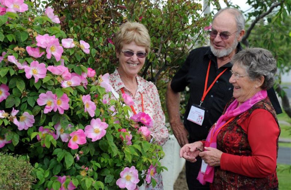 Mosgiel  garden host Ann Williams (right) shows South Australian couple Sue and John Zwar her...