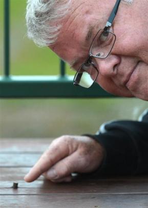 Mosgiel man John Elliott points to the bullet he found in his hardwood deck. Photos by Peter...