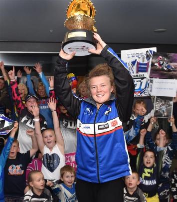 Motocross rider Courtney Duncan shows off the trophy she won at women’s world motocross...