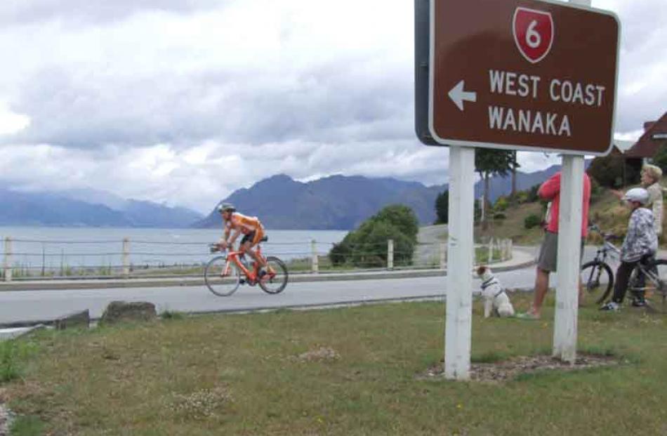 Small crowds lined scenic vantage points around the cycling and running courses to cheer...